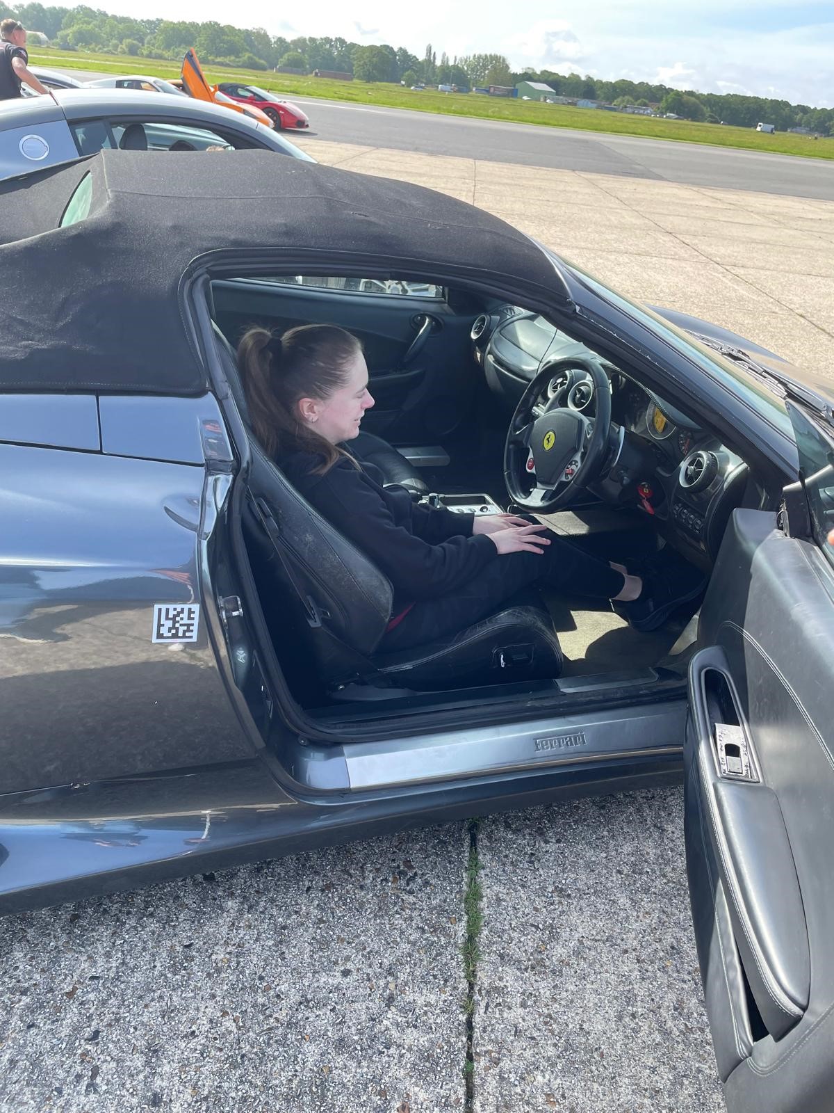 Charlotte smiling in the drivers seat